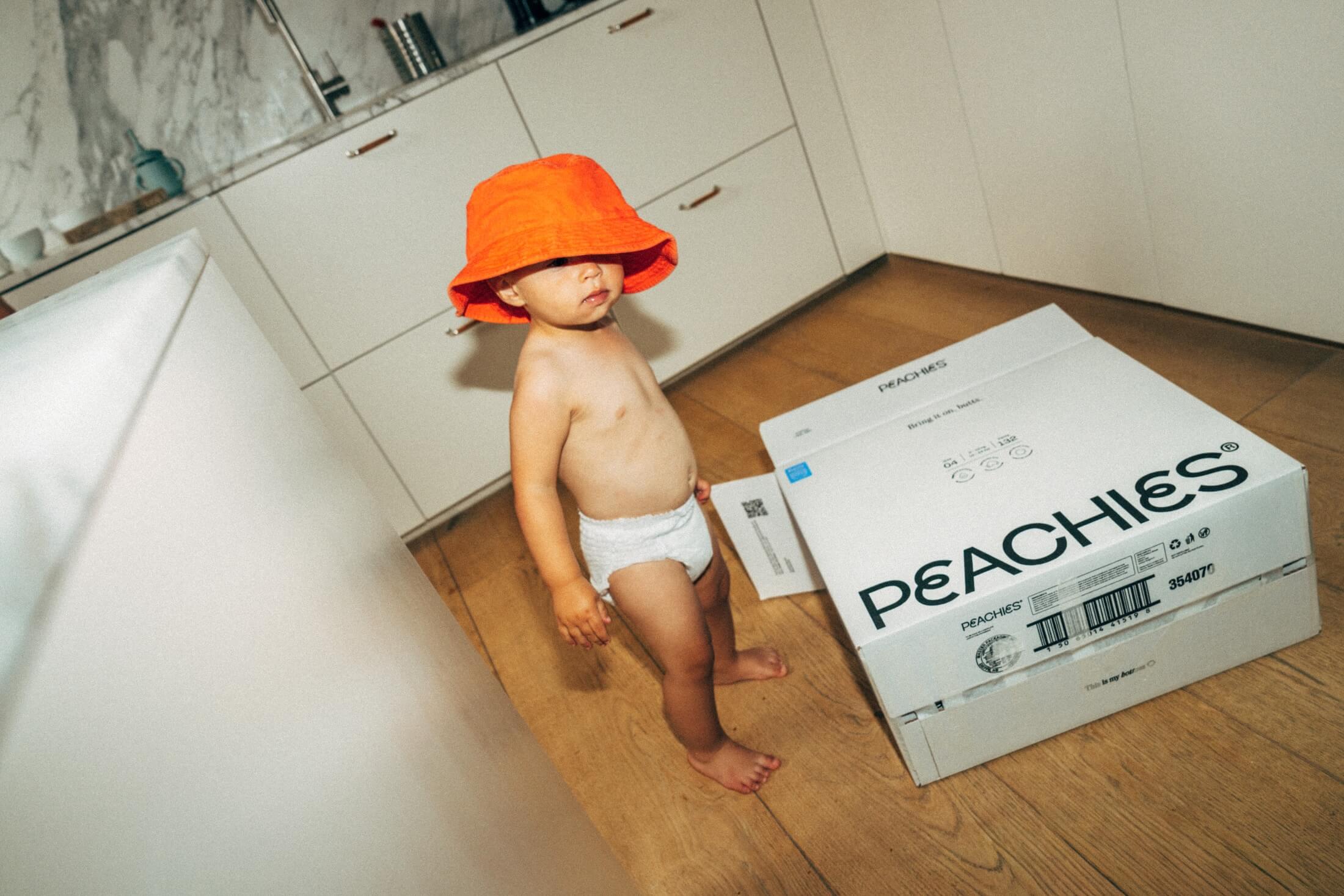 baby in an orange fisherman hat